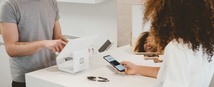 man in grey crew-neck t-shirt smiling to woman on counter